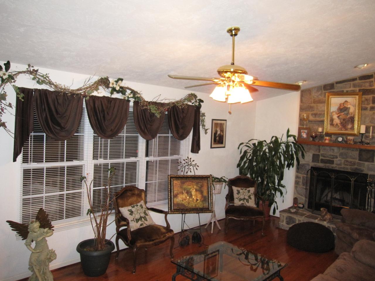 2169 Deep Woods Road Hardy, VA 24101 - Photo 34 of 37 a living room with furniture a fireplace and a chandelier