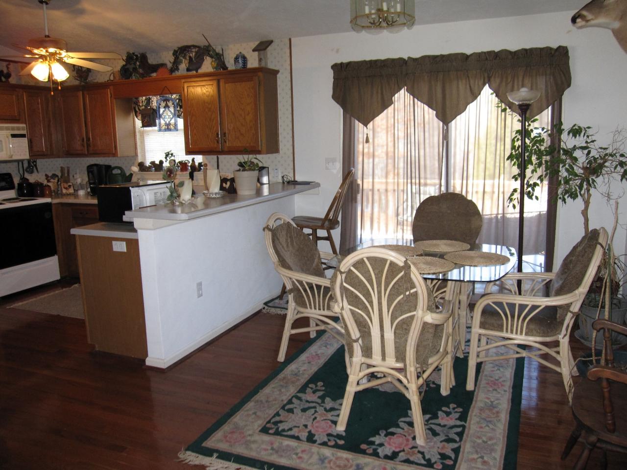 2169 Deep Woods Road Hardy, VA 24101 - Photo 7 of 37 a dining room with furniture a chandelier and wooden floor