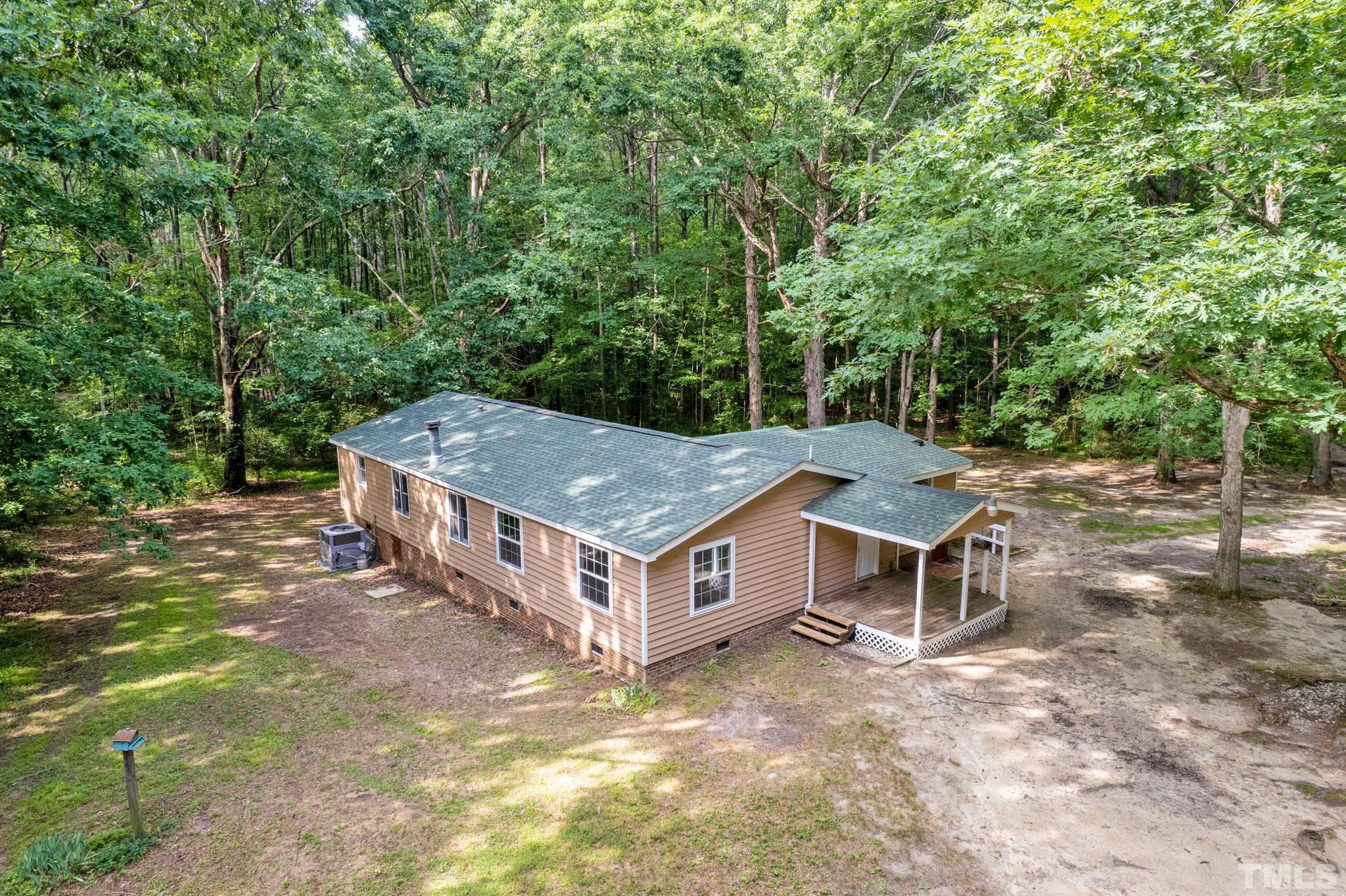 181 Simon Collie Road Louisburg, NC 27549 - Photo 26 of 26 a view of a house with a backyard and trees