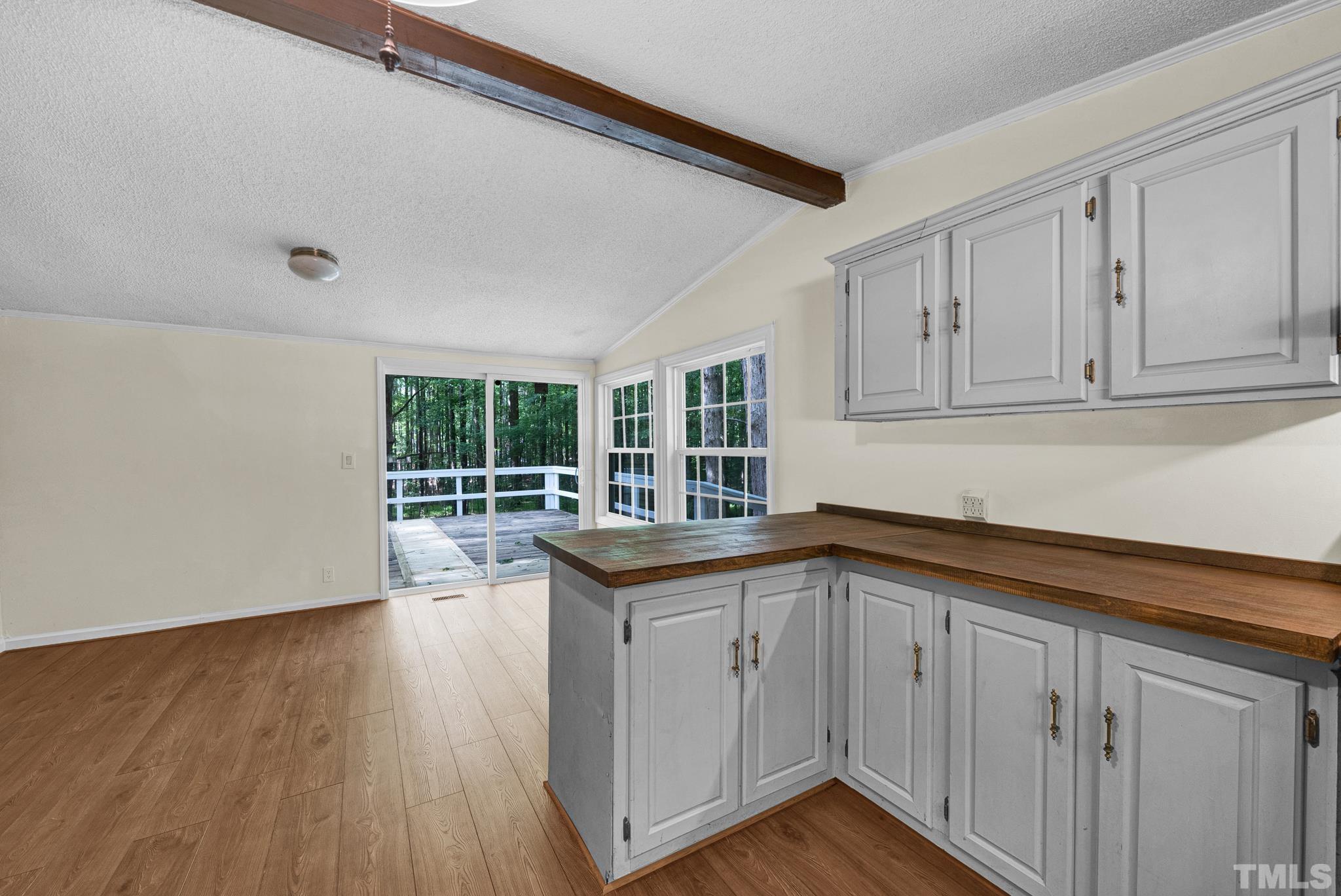 181 Simon Collie Road Louisburg, NC 27549 - Photo 7 of 26 a view of a kitchen with wooden floor and cabinets