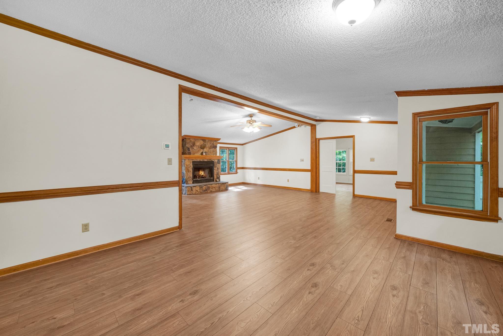 181 Simon Collie Road Louisburg, NC 27549 - Photo 10 of 26 a view of an empty room with wooden floor