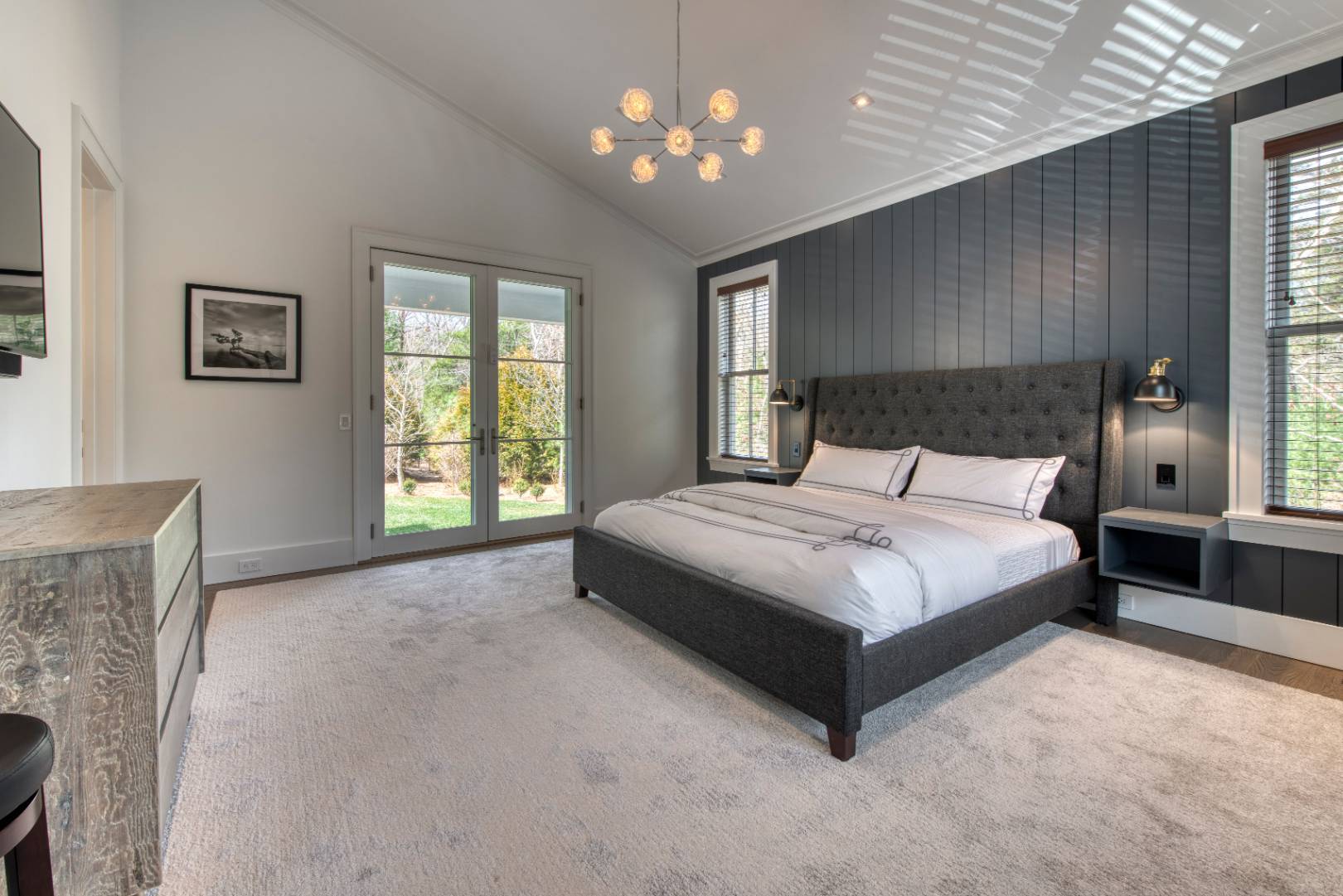 178 Bull Path East Hampton, NY 11937 - Photo 15 of 25 a bedroom with a large bed and a chandelier