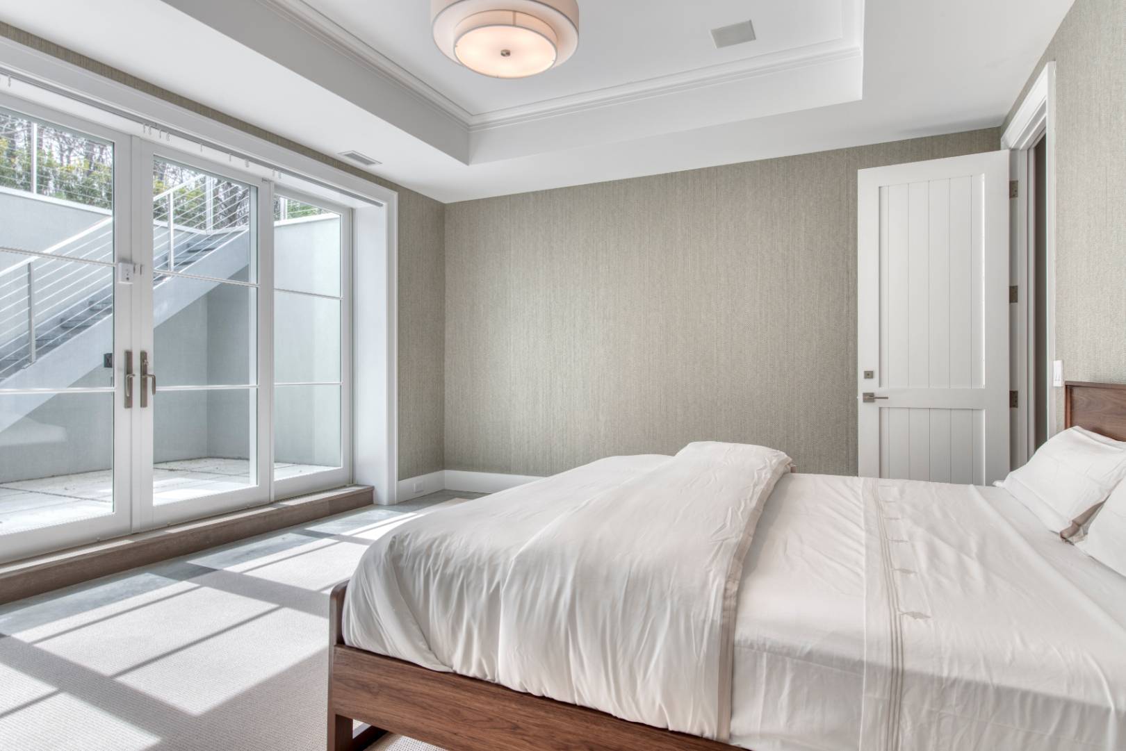 178 Bull Path East Hampton, NY 11937 - Photo 17 of 25 a bedroom with a bed and a large window