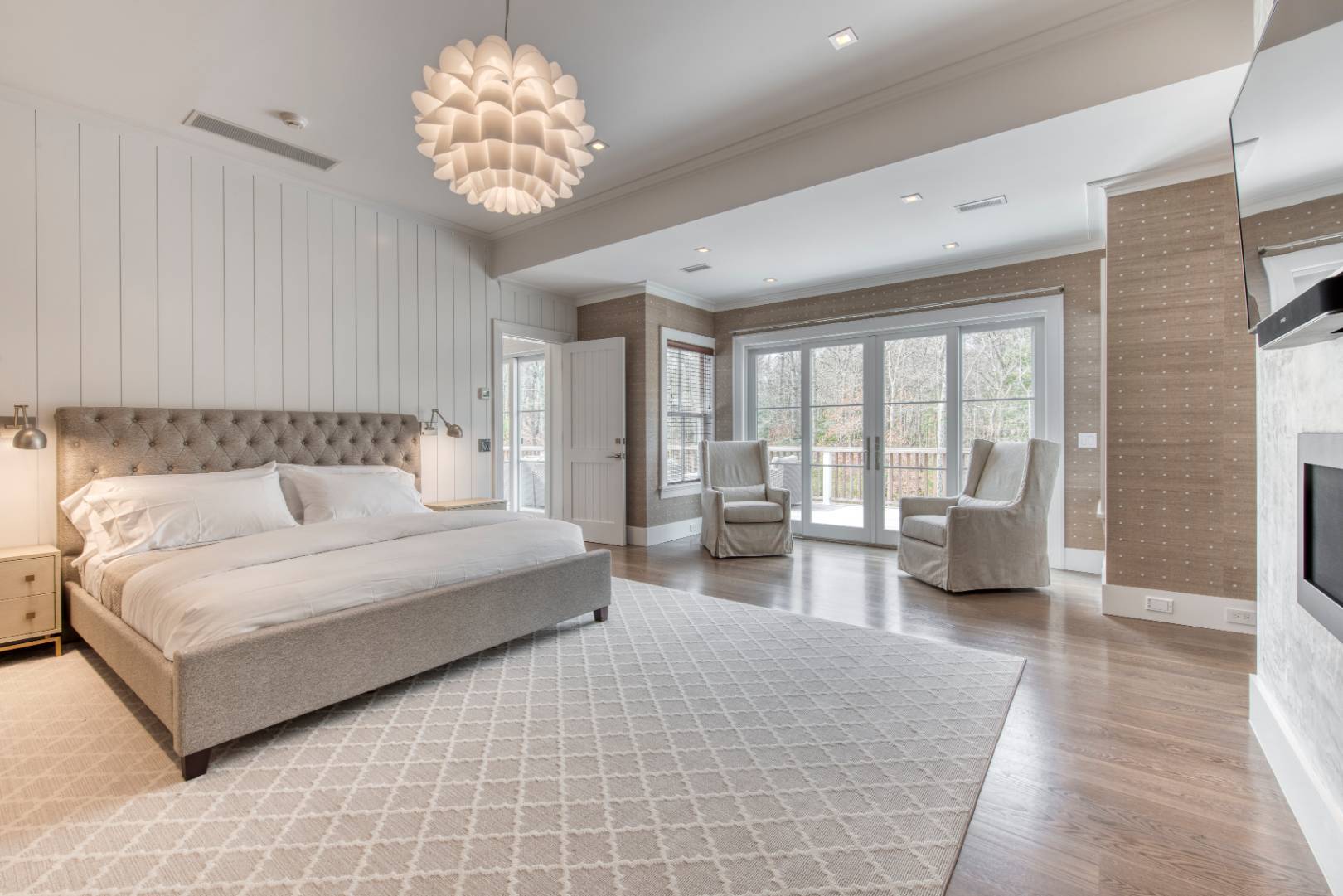 178 Bull Path East Hampton, NY 11937 - Photo 7 of 25 a spacious bedroom with a large bed and a chandelier
