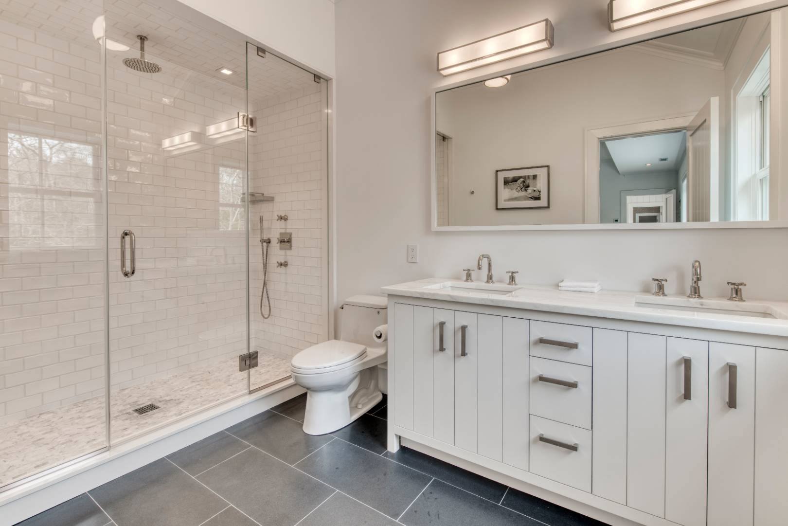 178 Bull Path East Hampton, NY 11937 - Photo 10 of 25 a bathroom with a shower sink vanity and mirror
