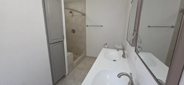 a bath room with a sink and shower