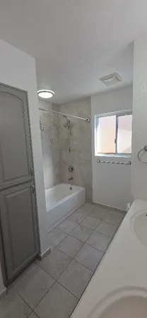 a spacious bathroom with a bathtub and window