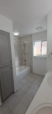 a spacious bathroom with a bathtub and window