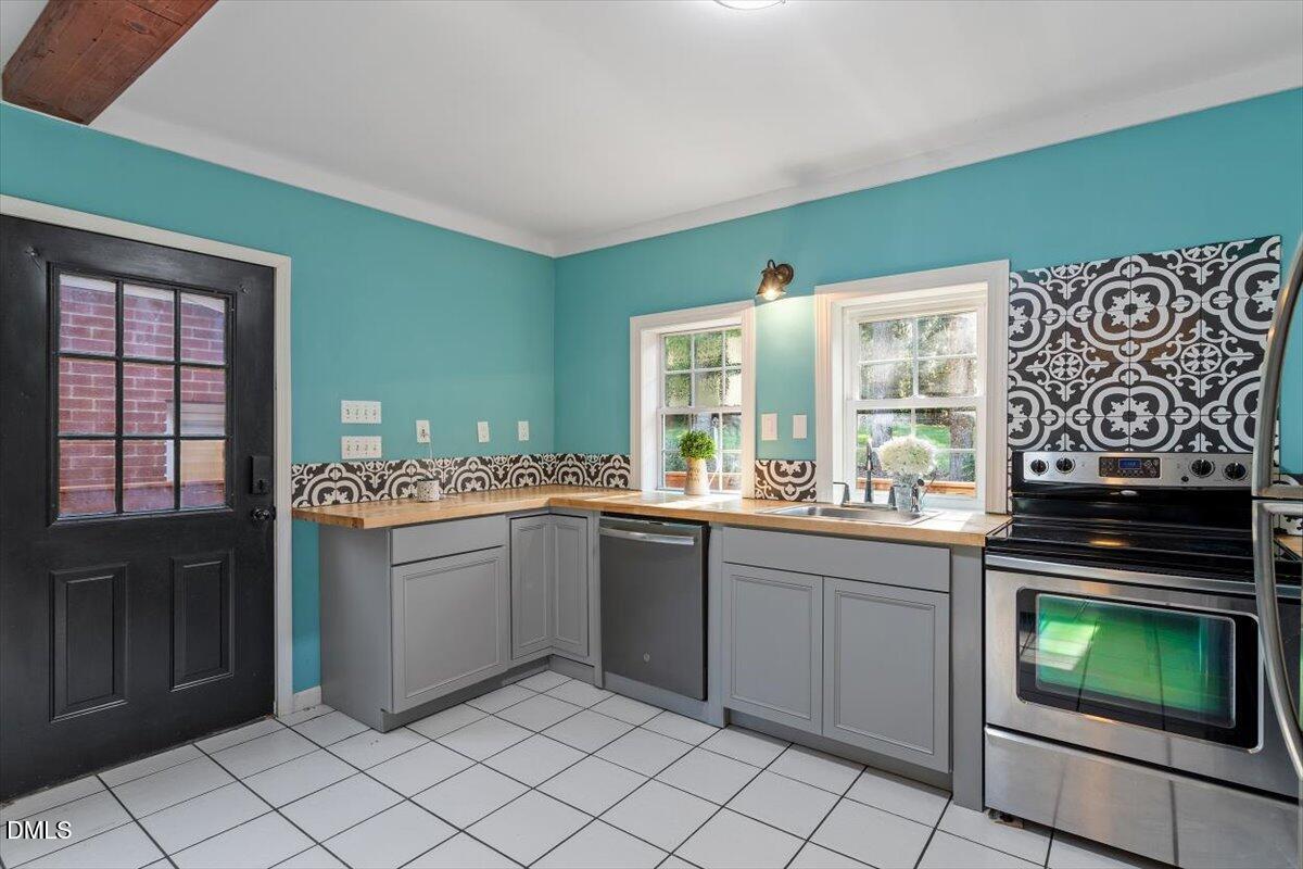 2129 Kelly Road Apex, NC 27502 - Photo 42 of 64 a kitchen with a sink cabinets and window