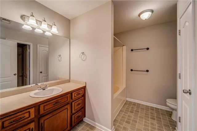 a bathroom with a sink a toilet a shower and a mirror