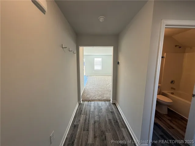 a view of a bathroom from a hallway