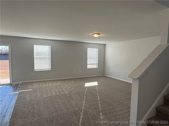 an empty room with a empty space and windows