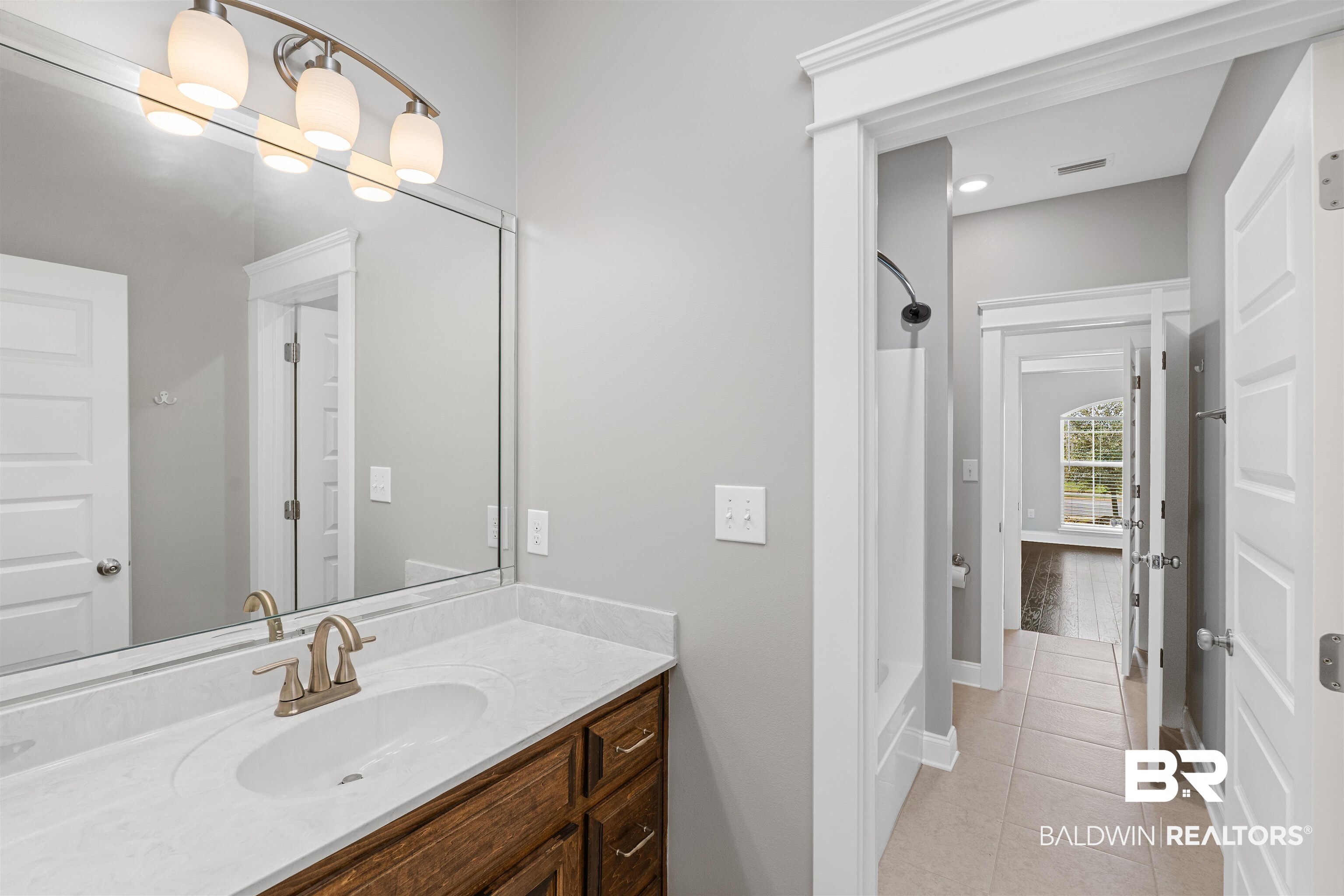 24838 Slater Mill Road Daphne, AL 36526 - Photo 27 of 46 Bathroom featuring vanity, shower / bath combination with curtain, and light tile patterned floors
