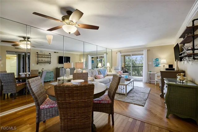 a view of a dining room with furniture a chandelier and wooden floor