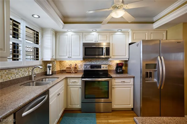 a kitchen with a sink stove and refrigerator