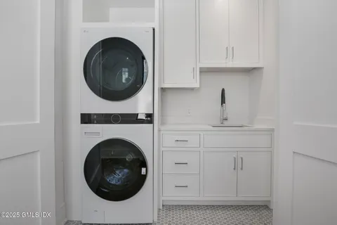 a utility room with sink dryer and washer