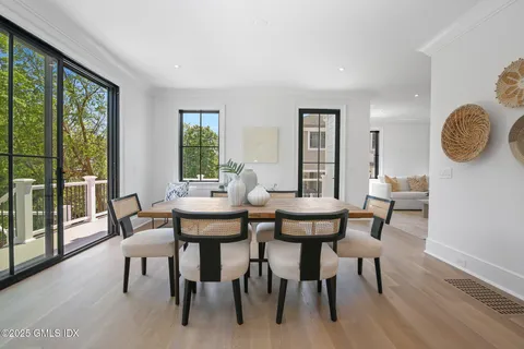 a view of a dining room with furniture wooden floor and a potted plant