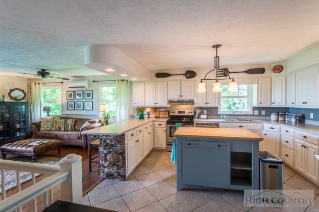 1115 Deck Hill Road Boone, NC 28607 - Photo 1 of 35 a kitchen with stainless steel appliances kitchen island granite countertop a sink and cabinets