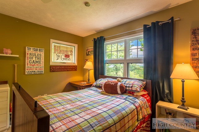 1115 Deck Hill Road Boone, NC 28607 - Photo 18 of 35 a bedroom with a bed and a window