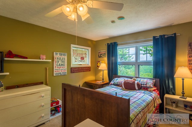 1115 Deck Hill Road Boone, NC 28607 - Photo 19 of 35 a bedroom with a bed and a window