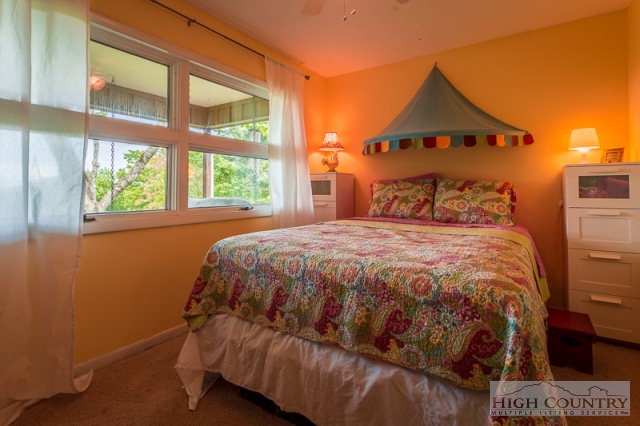 1115 Deck Hill Road Boone, NC 28607 - Photo 20 of 35 a bedroom with a bed and a window