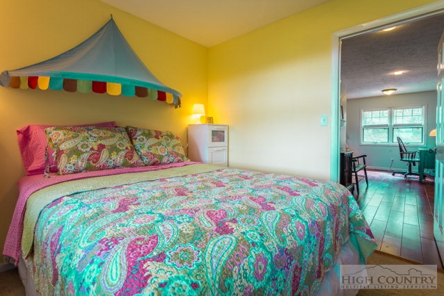 1115 Deck Hill Road Boone, NC 28607 - Photo 21 of 35 a bedroom with a bed and a view of swimming pool