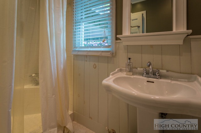 1115 Deck Hill Road Boone, NC 28607 - Photo 22 of 35 a bathroom with a sink a vanity and a mirror
