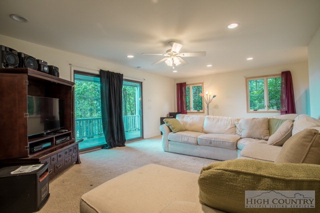 1115 Deck Hill Road Boone, NC 28607 - Photo 26 of 35 a living room with furniture and a flat screen tv
