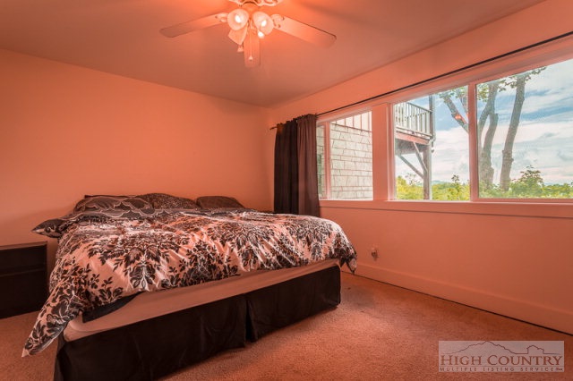 1115 Deck Hill Road Boone, NC 28607 - Photo 28 of 35 a bed sitting in a bedroom next to a window