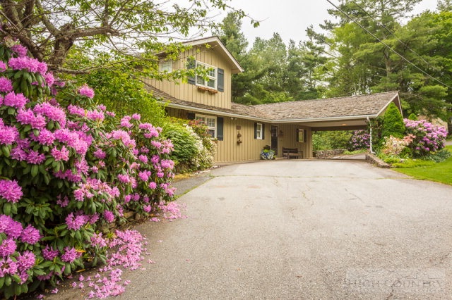 1115 Deck Hill Road Boone, NC 28607 - Photo 31 of 35 a front view of a house with a flower garden