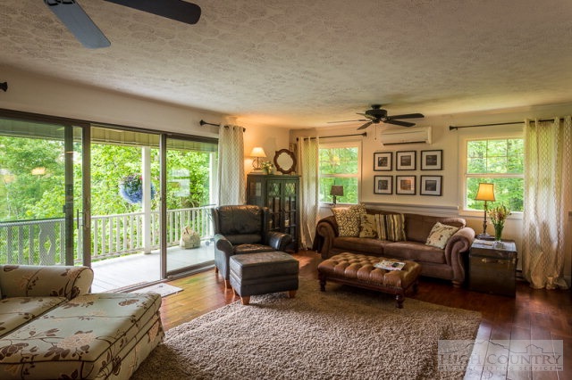 1115 Deck Hill Road Boone, NC 28607 - Photo 34 of 35 a living room with furniture and a floor to ceiling window
