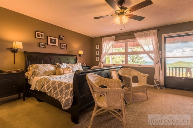 1115 Deck Hill Road Boone, NC 28607 - Photo 5 of 35 a bed room with a bed and a large window