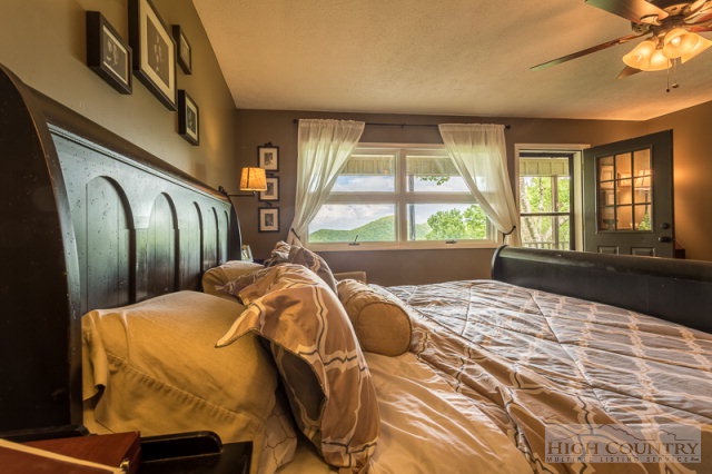 1115 Deck Hill Road Boone, NC 28607 - Photo 6 of 35 a bed sitting in a bedroom next to a window
