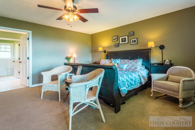 1115 Deck Hill Road Boone, NC 28607 - Photo 7 of 35 a bedroom with furniture and a ceiling fan