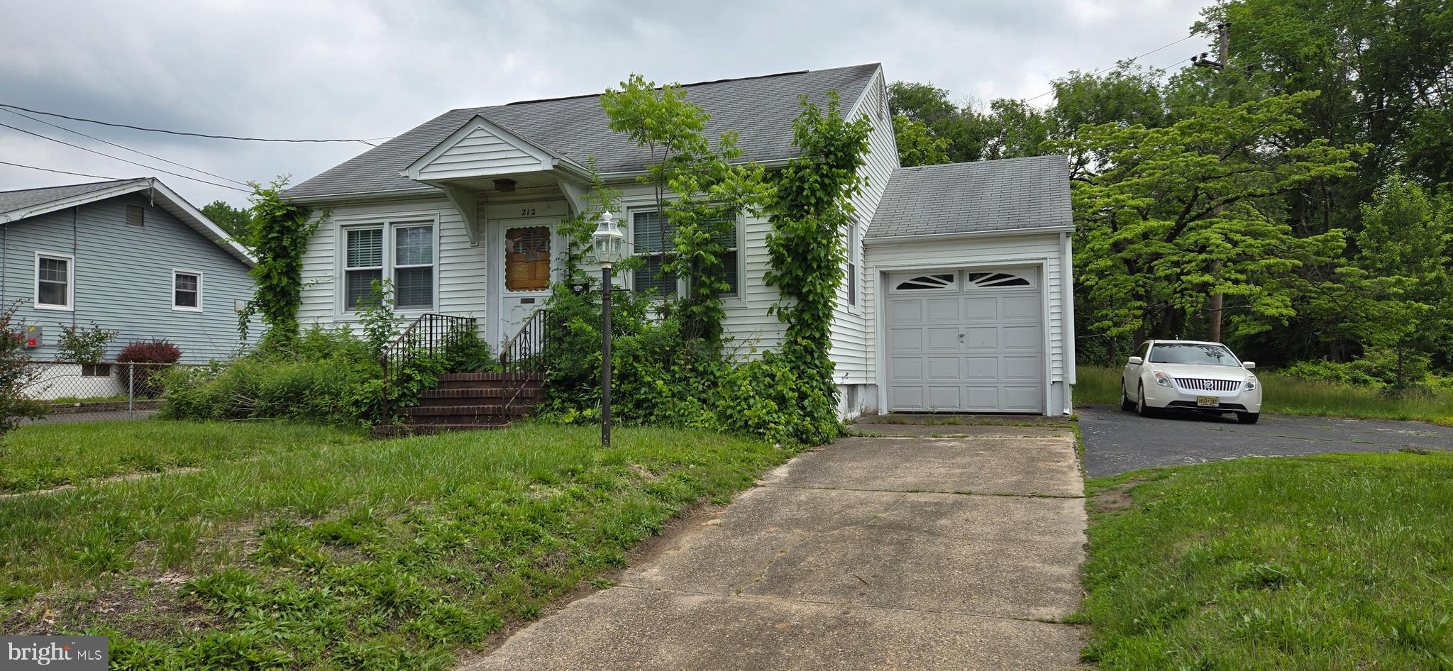 a view of a house with a backyard and sitting area