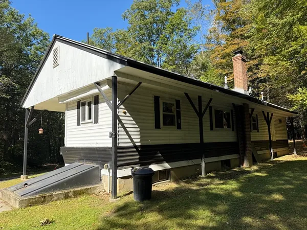 a backyard of a house with wooden floor and fence