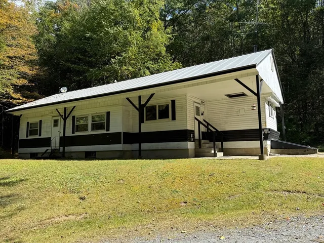 a view of house with backyard