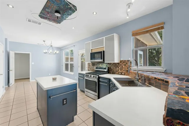 a kitchen with a stove a sink and a refrigerator