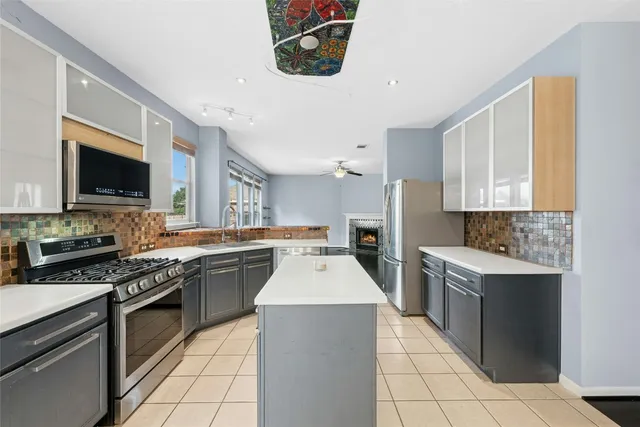 a kitchen with a sink stove and microwave