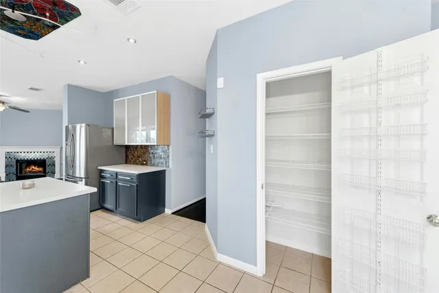 a large white kitchen with cabinets