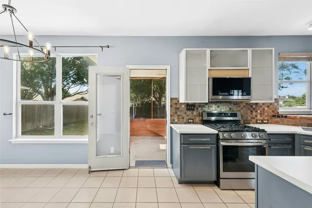 a kitchen with stainless steel appliances granite countertop a stove and a refrigerator