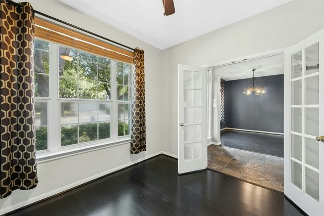 a view of wooden floor and windows in a room