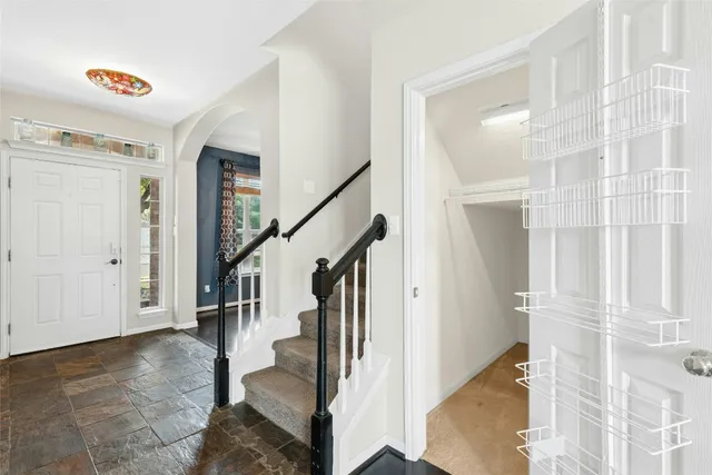 a view of entryway with furniture and wooden floor
