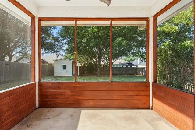 a view of a room with wooden floor and outdoor view