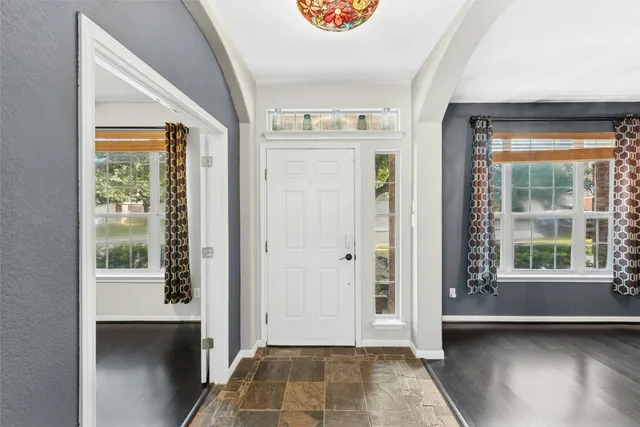 a view of a hallway with windows and entryway