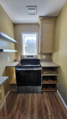 a view of a a dining room with furniture window and wooden floor