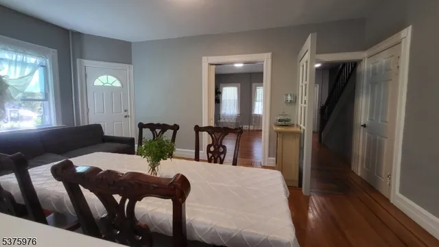 a view of hallway with stairs and wooden floor