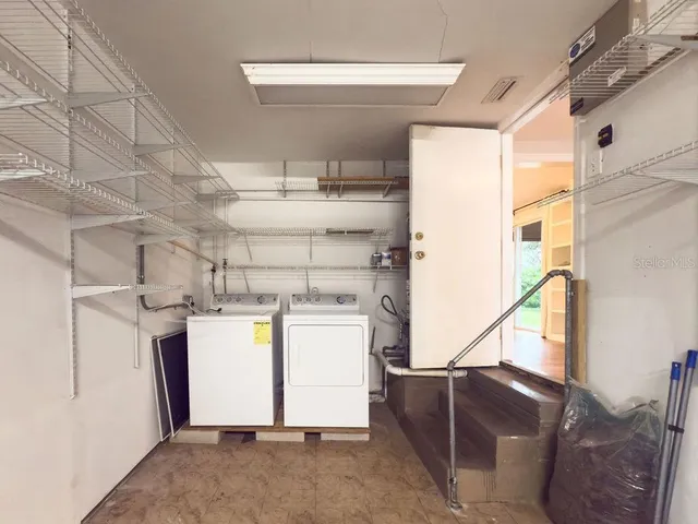 a view of storage and utility room with washer and dryer