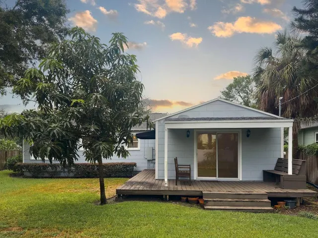 front view of a house with a yard patio and fire pit