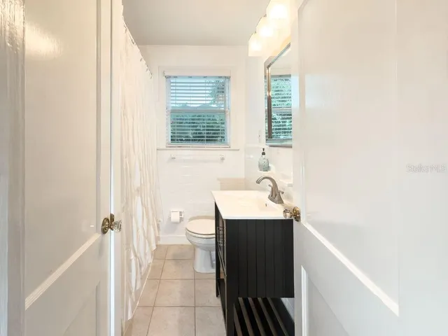 a bathroom with a sink a toilet and tub